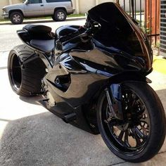 a black motorcycle parked in front of a building