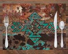 a placemat with an abstract design and two forks on it, next to a knife and fork