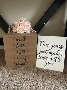 two boxes that have flowers in them on the floor next to some cards with sayings