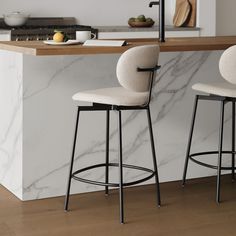 two stools sitting in front of a counter top