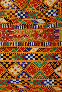 an elaborately designed cloth with many colors and patterns