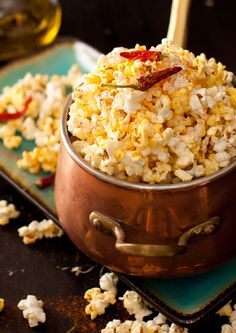 popcorn in a copper bowl on a green tray