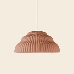 a brown light hanging from a ceiling fixture with a white wall in the back ground