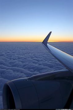 the wing of an airplane as it flies above the clouds