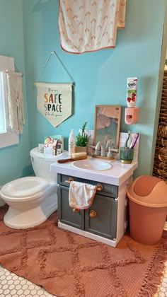 a bathroom with a toilet, sink and rug