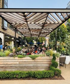 an outdoor seating area with people eating and drinking