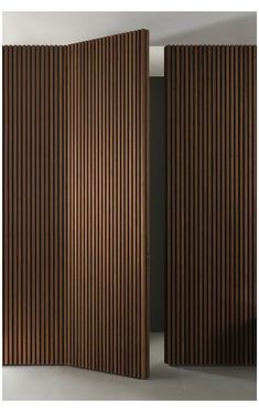 a room divider made out of wood with vertical slats on the sides and an open door