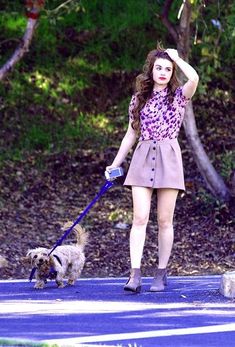 a woman walking her dog on a leash