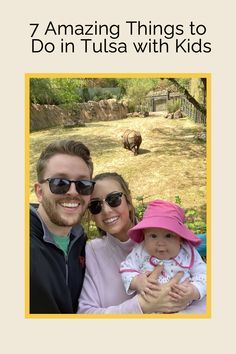 a man, woman and child are smiling at the camera with an animal in the background