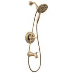 a shower head with thermostaer and handset in brushed brass finish on an isolated white background