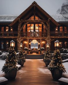 a large house covered in christmas lights and decorated with pine cones on the front porch