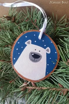 a polar bear ornament hanging from a tree