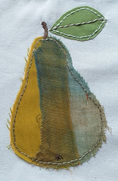 a piece of cloth has been stitched together with different colored threads and leaves