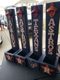 three houston astros trophies on display in front of a car