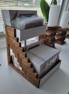 a stack of files sitting on top of a desk next to a window