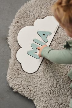 a young child is playing with a paper cut out of the shape of a flower