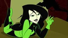 an animated image of a woman with green eyes and black hair wearing a witches hat