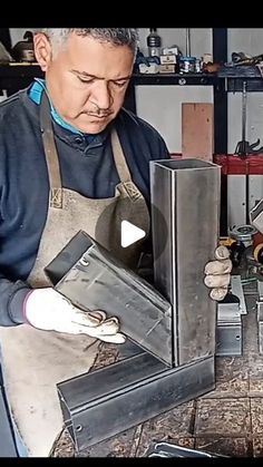 a man in an apron working on some metal items