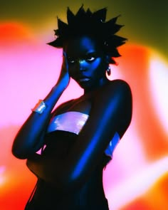 a woman with black hair and piercings on her head is posing in front of a neon background