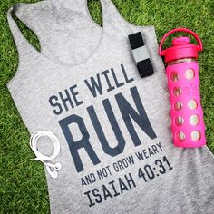 a shirt that says she will run and not grow weary with a water bottle next to it