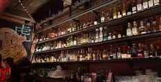 the bar is full of liquor bottles and glasses