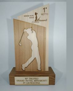 a wooden trophy with a golf player on it