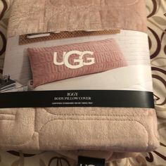 the ugg bedding set is pink and has two pillows on top of it