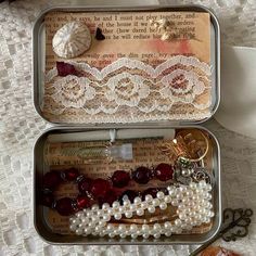 two tins filled with different types of jewelry