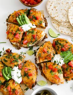 mexican food with tortillas, salsa and guacamole on the side