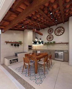 an open kitchen and dining room area with wooden beams on the ceiling, tile flooring and white walls