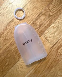 a plastic bottle with the word dirty written on it next to a rubber o - ring