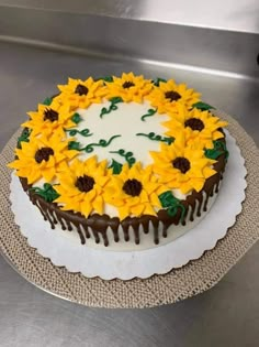 a cake decorated with sunflowers and chocolate icing