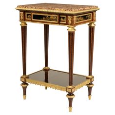 an ornately decorated side table with glass shelves and gold trimmings on the top