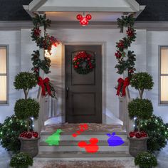 a house decorated for christmas with mickey mouse decorations on the front door and wreaths