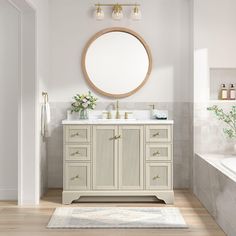 a bathroom with a sink, mirror and bathtub in the middle of the room