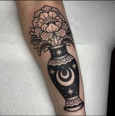 a black and white vase with flowers in it on the arm, by tattoo artist person