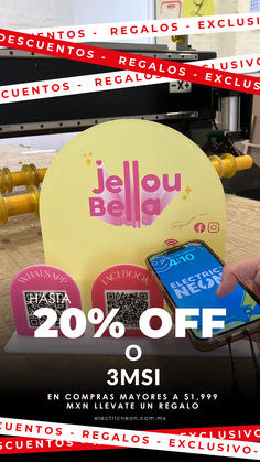 a person holding a cell phone in front of a sign that says jello belga 20 % off