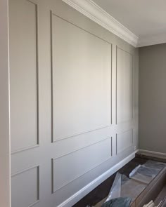 an empty room with white paneling on the walls