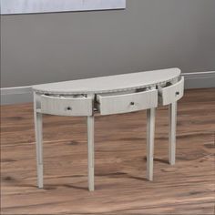 a white console table with two drawers on each side and one drawer at the top