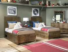 two wooden beds sitting next to each other on top of a carpeted room floor