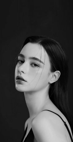 a black and white photo of a woman with long hair