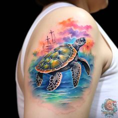 a woman's arm with a tattoo of a sea turtle and the cross in the background