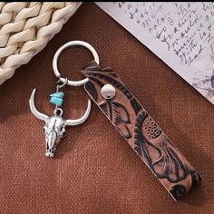 a keychain with a cow skull on it