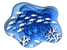 paper cut out of the shape of an ocean scene with fish and corals