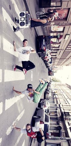 three men standing on the side of a building