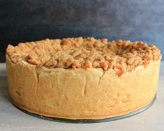 a cake sitting on top of a pan covered in crumbs