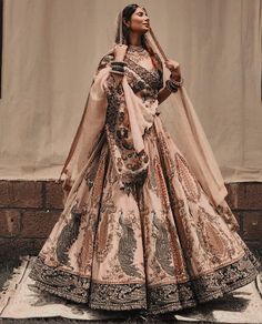 a woman in a wedding dress standing on the street