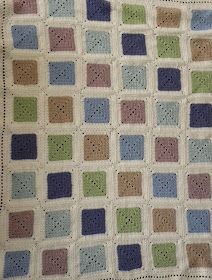 a crocheted blanket with squares on it