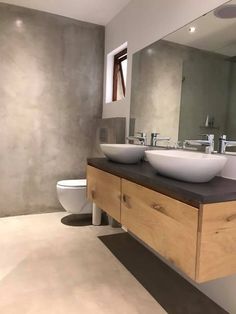 a bathroom with two sinks and a toilet