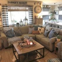 a living room filled with furniture and a clock on the wall above it's windows